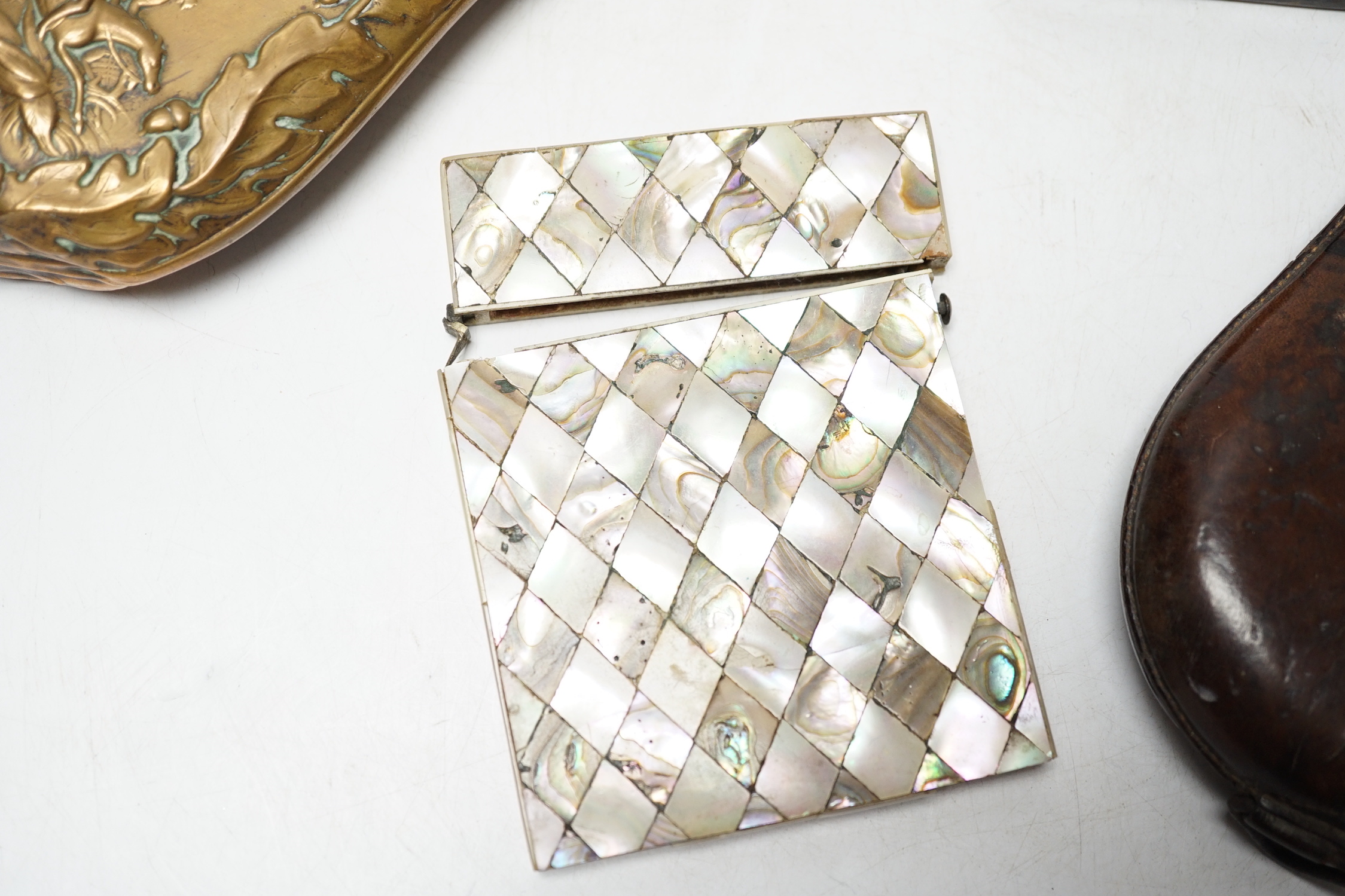 A Victorian embossed brass powder flask, a leather shot flask and a Victorian mother of pearl and abalone calling card case